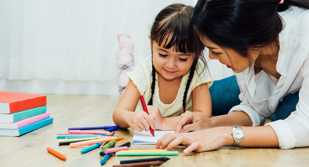 a girl coloring with markers